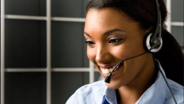Customer service representative talking into a headset at call center